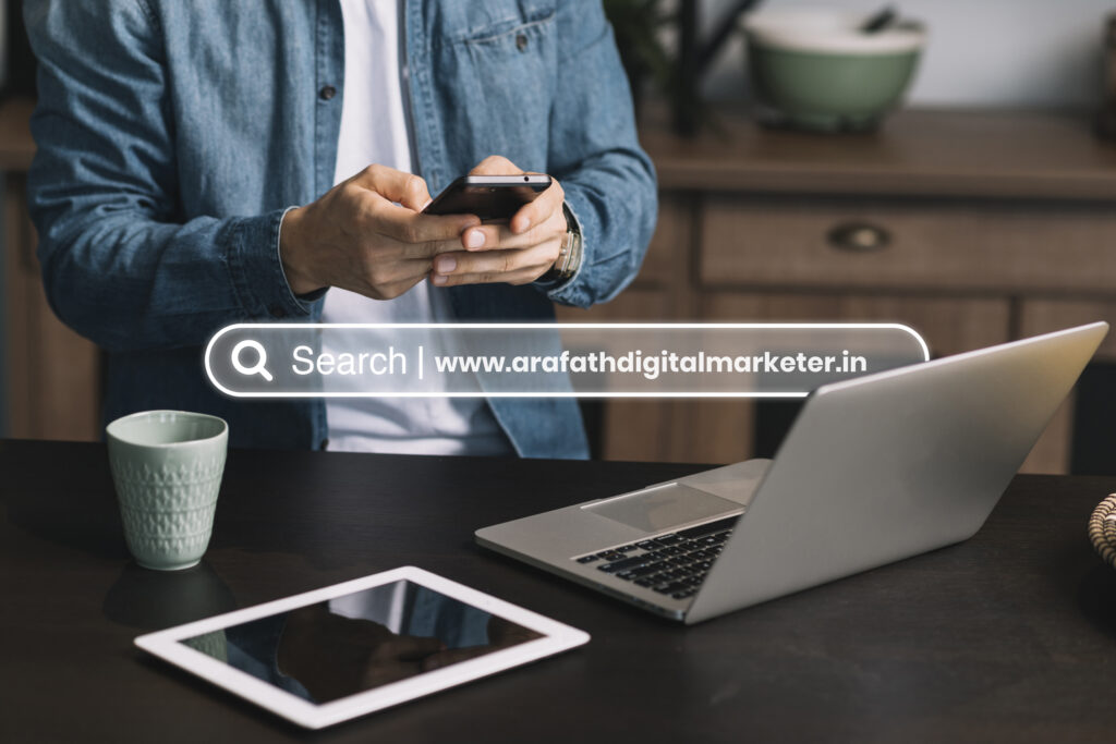 Person using smartphone and laptop with tablet on desk, digital marketing concept with www.arafathdigitalmarketer.in Digital Marketer